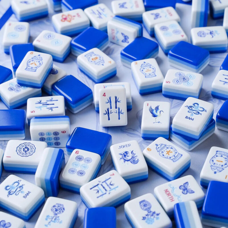 Blue and white American mahjong tiles showing several suits and specialty tiles